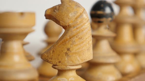 Close-up of white player knight  positioned  on  chequered fields slow tilt 4K 2160p 30fps UltraHD  