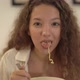 Cheerful Mixed Race Lady with Curly Hair Eats Noodles - VideoHive Item for Sale