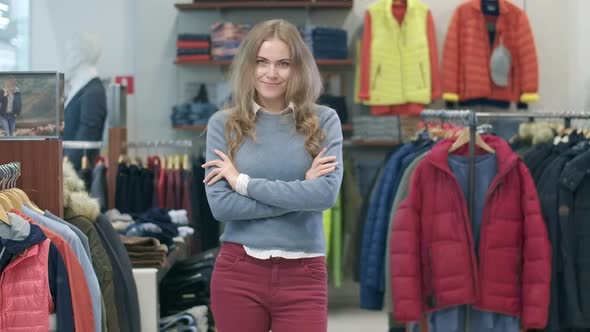 Portrait of Beautiful Young Caucasian Woman Posing in Clothing Shop. Charming Female Shopper