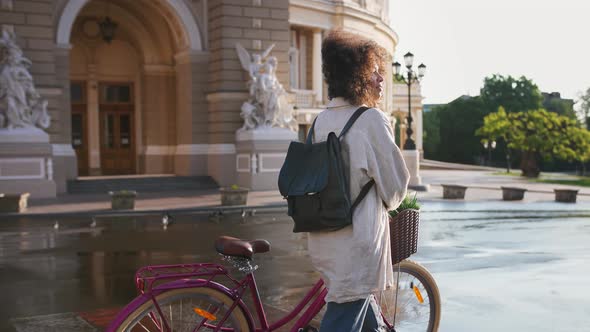 Africanamerican Girl in Casual Clothes Walking By Deserted Street Along Beautiful Building Crossing