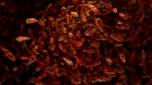 Super Slow Motion Shot of Dried Red Chili Peppers Explosion on Black Background at 1000Fps