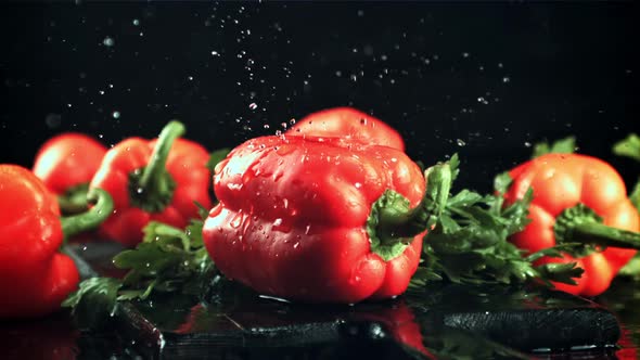 Drops of Water with Splashes Fall on the Sweet Pepper