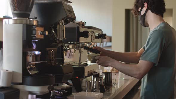 Male Barista Making Coffee Using Coffee Machine