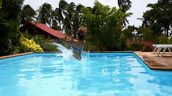 Woman Jumping into Swimming Pool