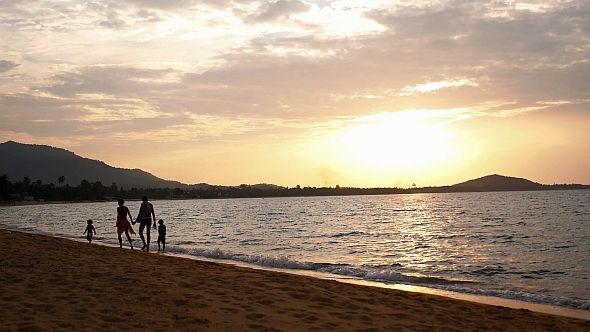 Happy Family Walking on Beach alt