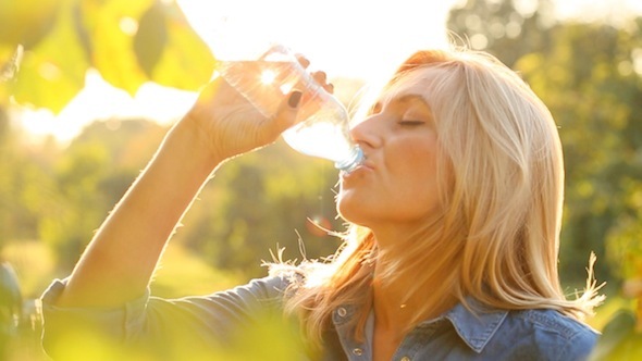 Woman Is Drinking Water In The Sun