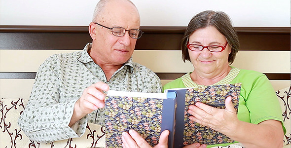 Senior Couple Watching Photo Album