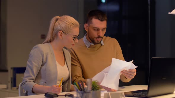 Business Team Celebrating Success at Night Office