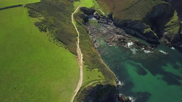 Coastal Walk Near The Port Isaac Surrounded By The Lush Green Grass And Turquoise Blue Water In Summ