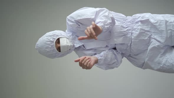 Vertical Video of the Funny Medical Worker in Bio Hazard Protective White Uniform Dancing