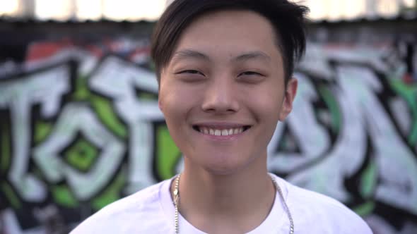 Happy Kind Young Asian Male Teenager Smiling Outdoors