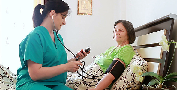 Nurse Checking Blood Pressure to Senior Woman 