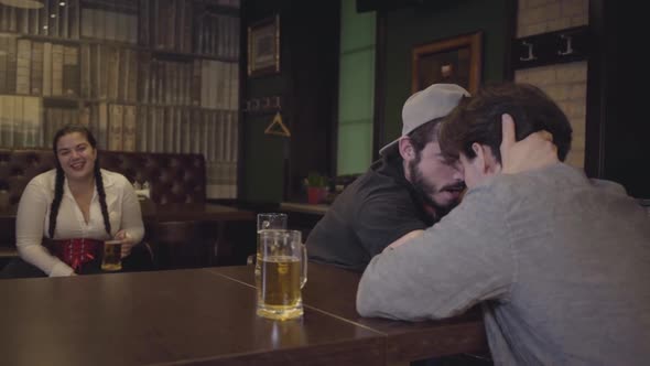 Two Men Sitting at a Table in a Bar, Engaged in Arm Wrestling