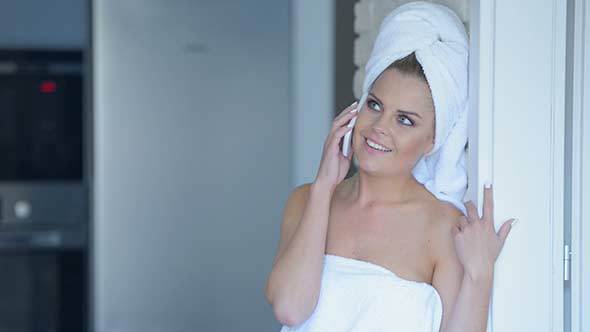 Woman in Bath Towel Talking on Cell Phone