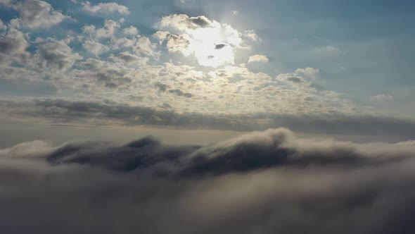 Above the clouds. Sunrise foggy morning.