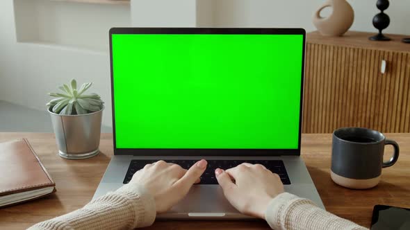 Female Hands Typing on Laptop Keyboard with Green Screen