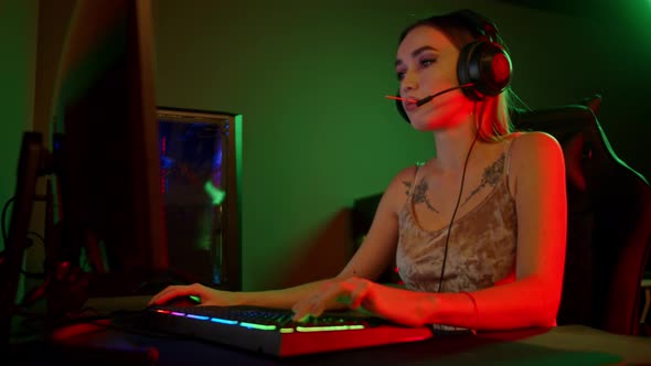 Sexy Young Woman Sitting By the PC and Playing Games