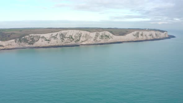 Aerial drone shot towards the white cliffs of dover over the sea