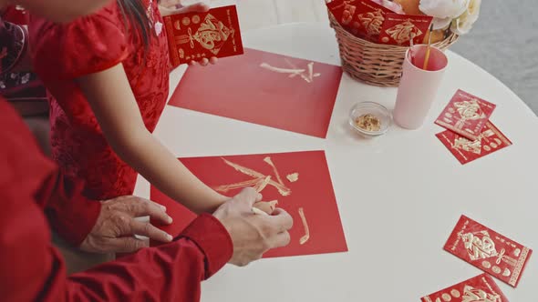 Father Helping Daughter Making Chinese New Year Postcard