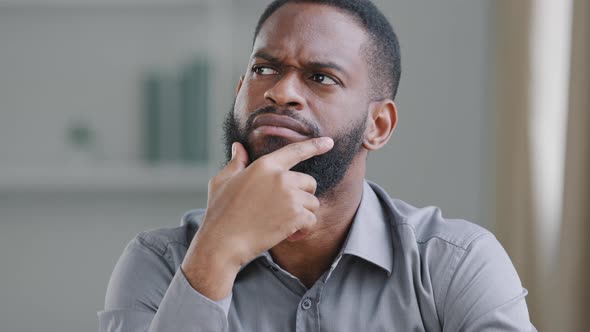 Pensive Bearded African American Man Thinking Broods Over Difficult Problem Suddenly Finds Perfect