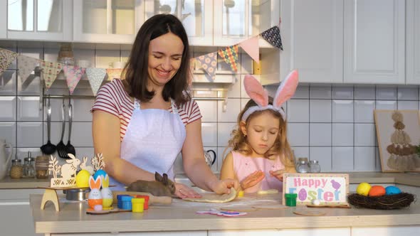 Family Rolling Dough with Easter Bunny in Kitchen