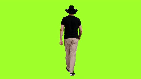 Walking Man in Black T-shirt and Cowboy Hat