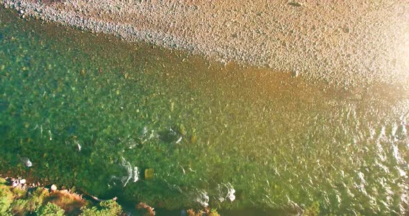 Low Altitude Flight Over Fresh Fast Mountain River with Rocks at Sunny Summer Morning