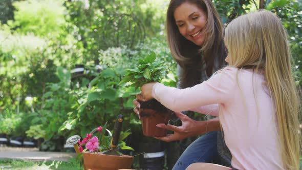 Mother and daughter are replanting in the garden