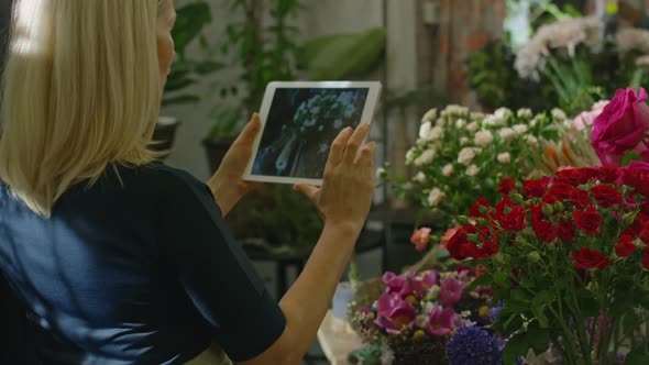 Women Photographing Flowers in Market