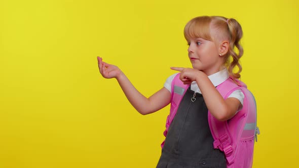 School Girl Kid in Uniform Showing Thumbs Up Pointing Left at Copy Space for Promotional Content