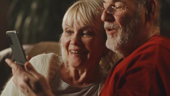 Happy Senior Couple Making Video Call to Relatives