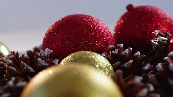 Close-up of christmas bauble and pine cone