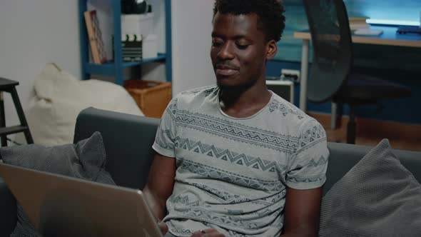 Black Man Working From Home for Business Project on Laptop