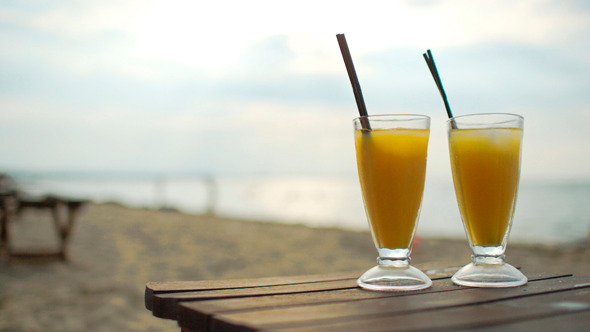 Two Cocktails On Wooden Table By The Sea