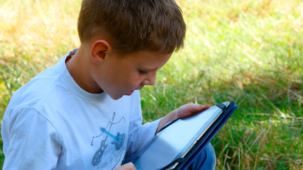 Happy Young Boy Using Tablet 2