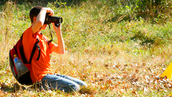 Young Boy Taking Photos With Dslr