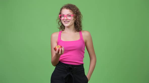 Young Happy Beautiful Nerd Woman Giving Red Apple