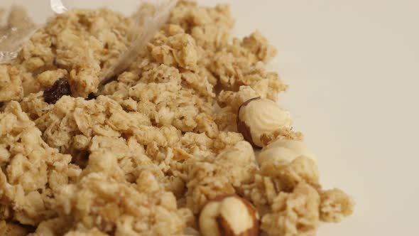 Pile of crunchy cereals close-up 4K 2160p 30fps UltraHD footage - Panning on muesli with whole hazel