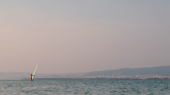 Windsurfer Sailing In Quiet Sea alt