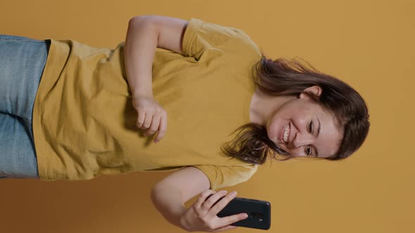 Casual Happy Woman in Video Call Conference Using Smartphone Waving Hello at Front Camera