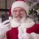 Kind Elderly Santa Claus Talking By Video Call Greeting His Interlocutor and Showing Thumb Up to - VideoHive Item for Sale