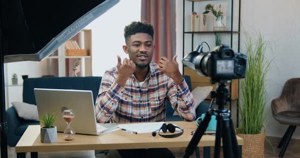 Man Sitting in front of Camera in Contemporary Home Office During Recording Videovlog