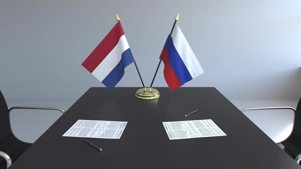 Flags of the Netherlands and Russia on the Table