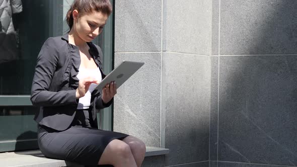 Business Woman Browsing Internet on Tablet