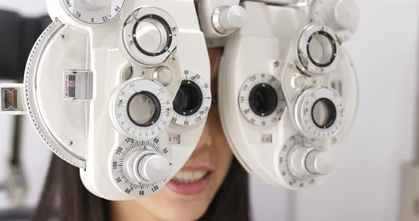 Young asian woman doing eye test 