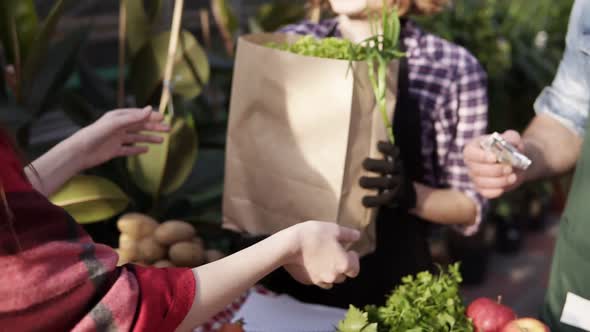 Unrecognizable People Selling Organic Food in a Local Harvest Market