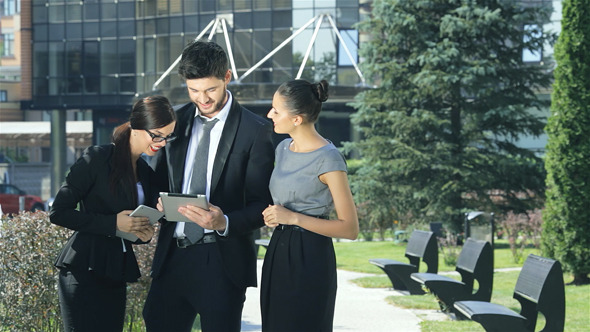 Company Of Three Business People Discussing