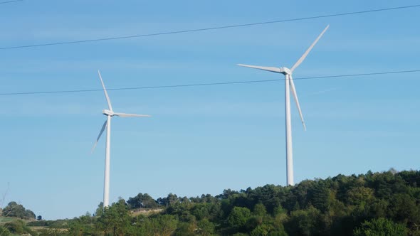 Windmill Farm Wind Electro Eco Energy Turbines on Blue Sky Background on European Pyrenees Mountains