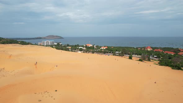 aerial of desert sand dunes near a highway road along the ocean in Mui Ne Vietnam