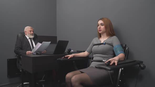 Concentrated Young Lady Telling Truth During Polygraph Test